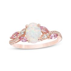 a white opal and pink tourmaline ring with diamonds on the sides, set in