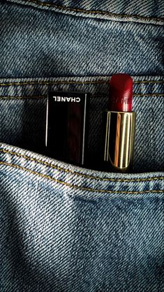 two lipsticks in the pocket of a pair of jeans