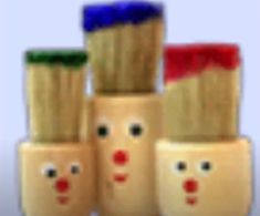 four wooden toys with faces on them are stacked in the shape of santa's hats