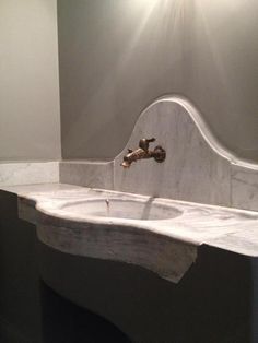 a white sink sitting under a mirror in a bathroom