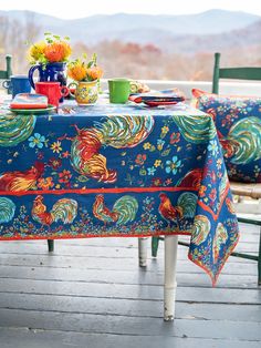 the table is set with colorful dishes and cups