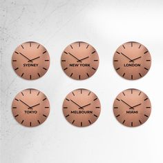 four clocks with the names of different cities on them