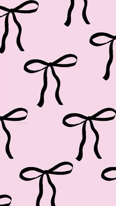 a pink background with black bows on it