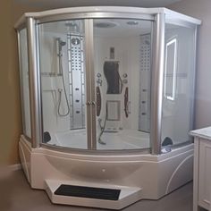 a bathroom with a walk in shower sitting next to a sink and counter top on the floor