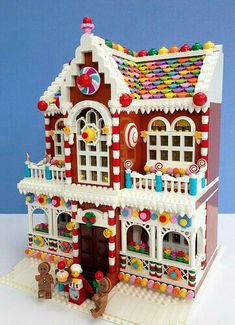 a toy house made out of legos with candy on the roof and front windows