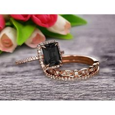 an engagement ring with a black stone surrounded by diamonds