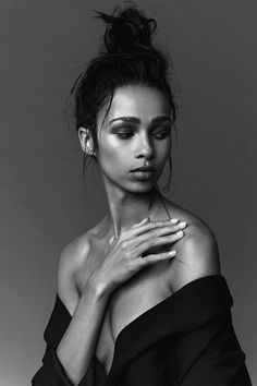 a black and white photo of a woman with her hands on her chest