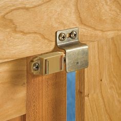 a close up of a wooden door with a metal hinge on the bottom part