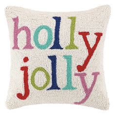 a decorative pillow with the words holly jolly on it in multicolored letters and dots