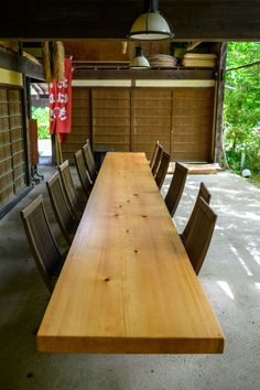 a long wooden table with chairs around it