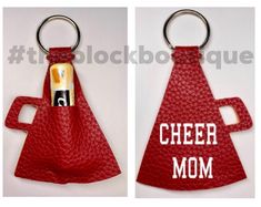 two pictures of a red leather keychain with the word cheer mom printed on it