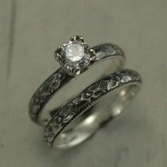 two silver rings with a diamond in the middle