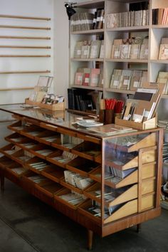 an old wooden desk with many books on it in a room filled with other items