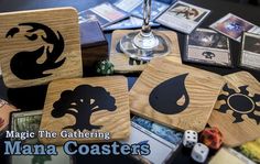 the wooden coasters have different designs on them and are next to dicers with cards