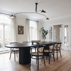 an image of a dining room setting with table and chairs in the center, light fixtures on the ceiling