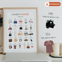 the modern family alphabet poster is displayed in front of a laptop computer and other items