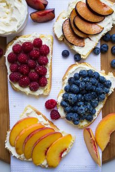 bread with fruit and cream on it sitting on a cutting board next to sliced peaches