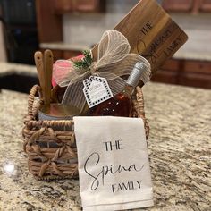 a small basket filled with food and wine on top of a kitchen counter next to a napkin