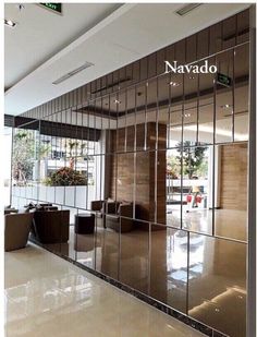 an office lobby with glass walls and chairs