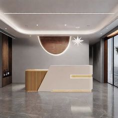 an empty lobby with large windows and a white reception counter in the center, surrounded by wood paneling