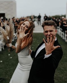 a man and woman standing next to each other in front of an outdoor wedding ceremony