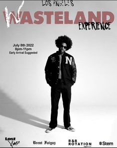 a man with an afro standing in front of a poster for the wasteland experience