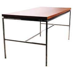 a wooden table with metal legs on a white background