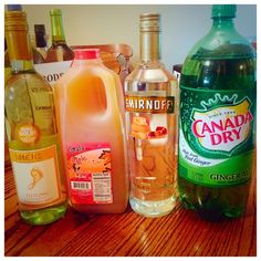 several bottles of alcohol sitting on top of a wooden table