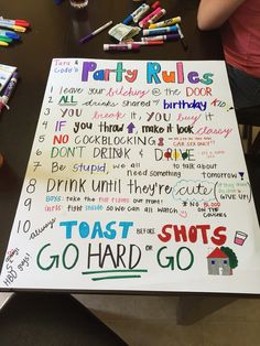 a birthday party rules sign on a table with crayons and markers around it