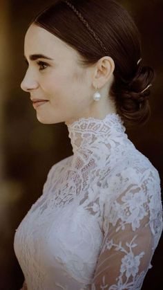 a woman wearing a white dress with a braid in her hair