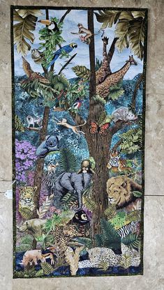 an animal themed wall hanging on the side of a building with trees and animals around it