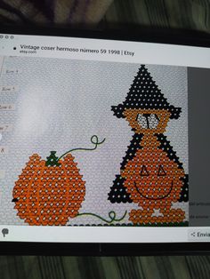 a computer screen with an image of a pumpkin and witch on it's face