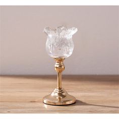 a glass vase sitting on top of a wooden table