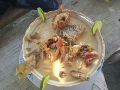 a bowl filled with food and garnished with limes