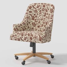 an upholstered office chair with wheels and a floral pattern on the backrest