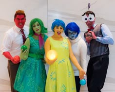 four people dressed in costumes posing for a photo