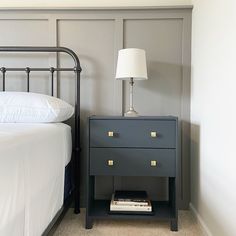 a nightstand next to a bed in a bedroom