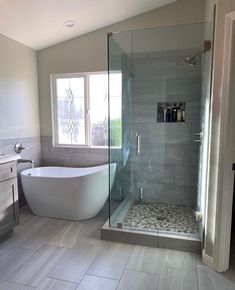 a bathroom with a bathtub, sink and window in the shower stall is shown