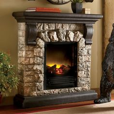 a fireplace with a bear statue next to it and a clock on the wall behind it