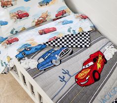 a bed with cars and checkered sheets on it