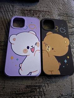 two cell phones are sitting next to each other on the floor, one has a cartoon bear and the other has a teddy bear