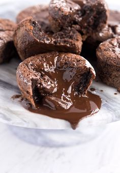 chocolate cupcakes on a plate with melted chocolate