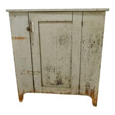 an old white cabinet with peeling paint on it's doors and bottom paneling