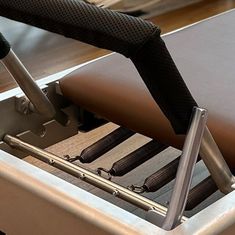 an empty seat on a train with metal bars