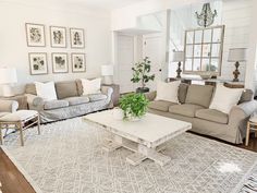 a living room with couches, chairs and a rug on the floor in front of them