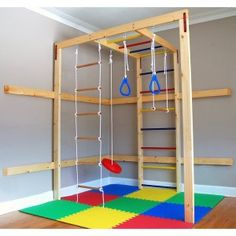 a play room with ladders and climbing ropes