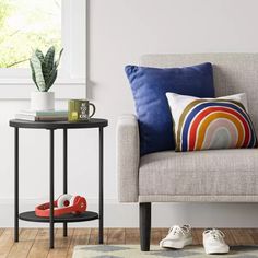 a living room with a couch, coffee table and potted plant