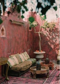 a living room filled with furniture and a potted plant on top of a table