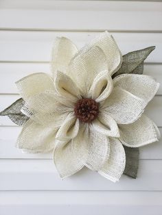 a large white flower with green leaves on it