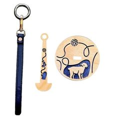 a wooden keychain with an animal design on it next to a bottle opener